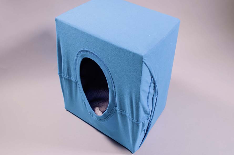 End result of cat hideaway made from a t-shirt and cardboard box