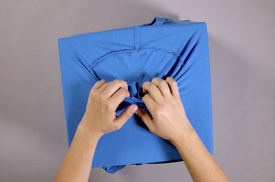 T-shirt being adjusted over cardboard box