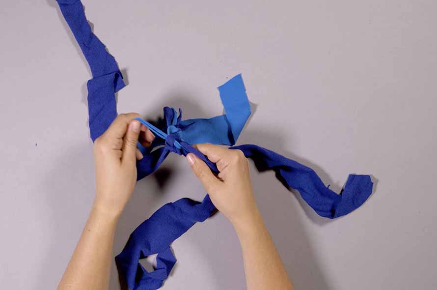 Pieces of fabric being tied together